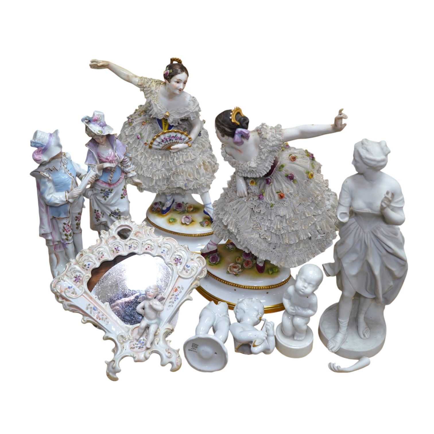 A collection of Continental porcelain ceramic figurines, including a pair of lace examples, dancing ladies and an easel mirror, largest 29cm high. Condition - mostly poor